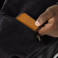 The user takes out their wallet from the pocket.